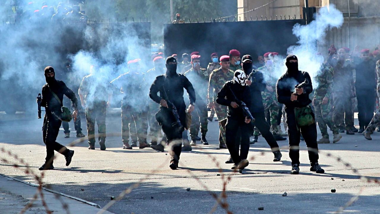 Security forces fire tear gas to disperse anti-government protesters in Baghdad.