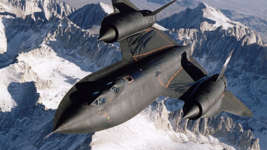 SR-71B Blackbird aerial reconnaissance aircraft photographed over snow capped mountains in 1995.