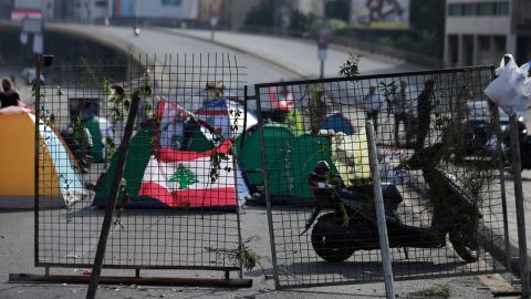 Anti-government protesters block the main highway linking east and west Beirut with tents, stones and bricks on Friday.