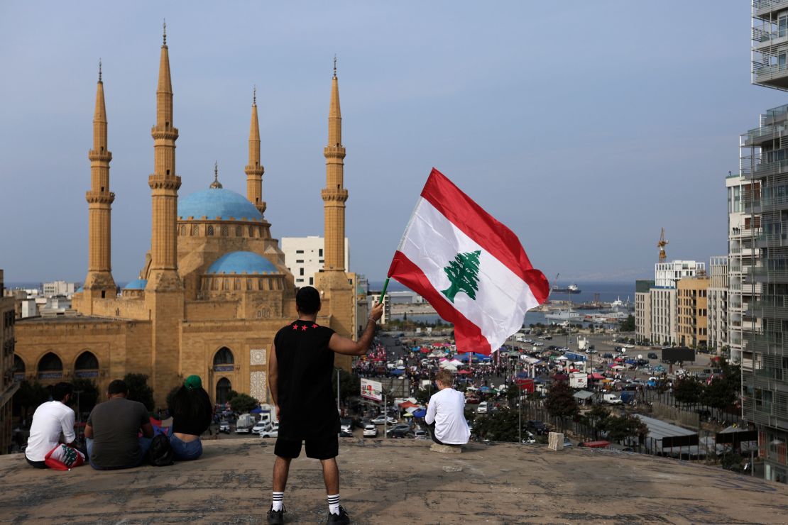 An anti-government protester holds up a Lebanese national flag in Beirut on Friday.