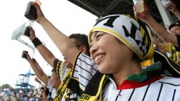TOKYO, JAPAN - JUNE 26: Fans make a simultaneous toast, raising their cups, in the Guinness World Record attempt for the largest toast during the fifth inning of the baseball game between the Tokyo Yakult Swallows and the Hanshin Tigers at Jingu Stadium on June 26, 2010 in Tokyo, Japan. The new record, officially confirmed by the adjudicator, was recorded at 27,126 people in the attempt to break the previous record which was 26,564 people at an event in Portugal in 2009. (Photo by Kiyoshi Ota/Getty Images)
