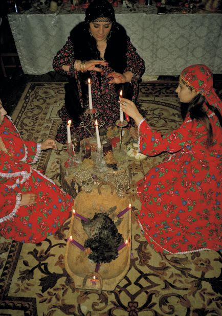 The witches light candles as part of a ritual.