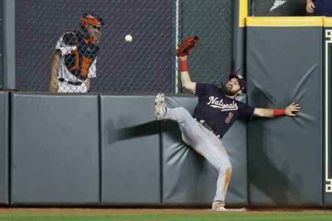 Eaton crashes into the wall as he tries to make a catch in Game 1.