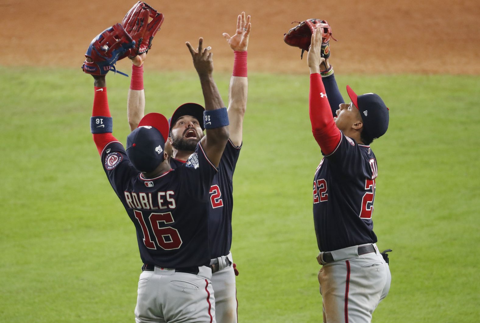 Washington outfielders Victor Robles, Adam Eaton and Juan Soto celebrate their 5-4 victory in Game 1.