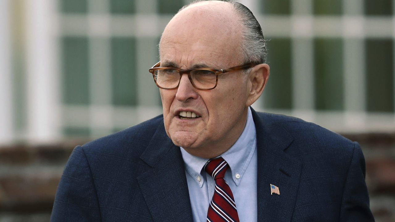 FILE - In this Nov. 20, 2016 file photo, former New York Mayor Rudy Giuliani arrives at the Trump National Golf Club Bedminster clubhouse in Bedminster, N.J. President Donald Trump's new lawyer Rudy Giuliani said Wednesday, May 2, 2018, the president repaid attorney Michael Cohen for a $130,000 payment to porn star Stormy Daniels. Giuliani made the revelation during an appearance on Fox News Channel's "Hannity." (AP Photo/Carolyn Kaster, File)