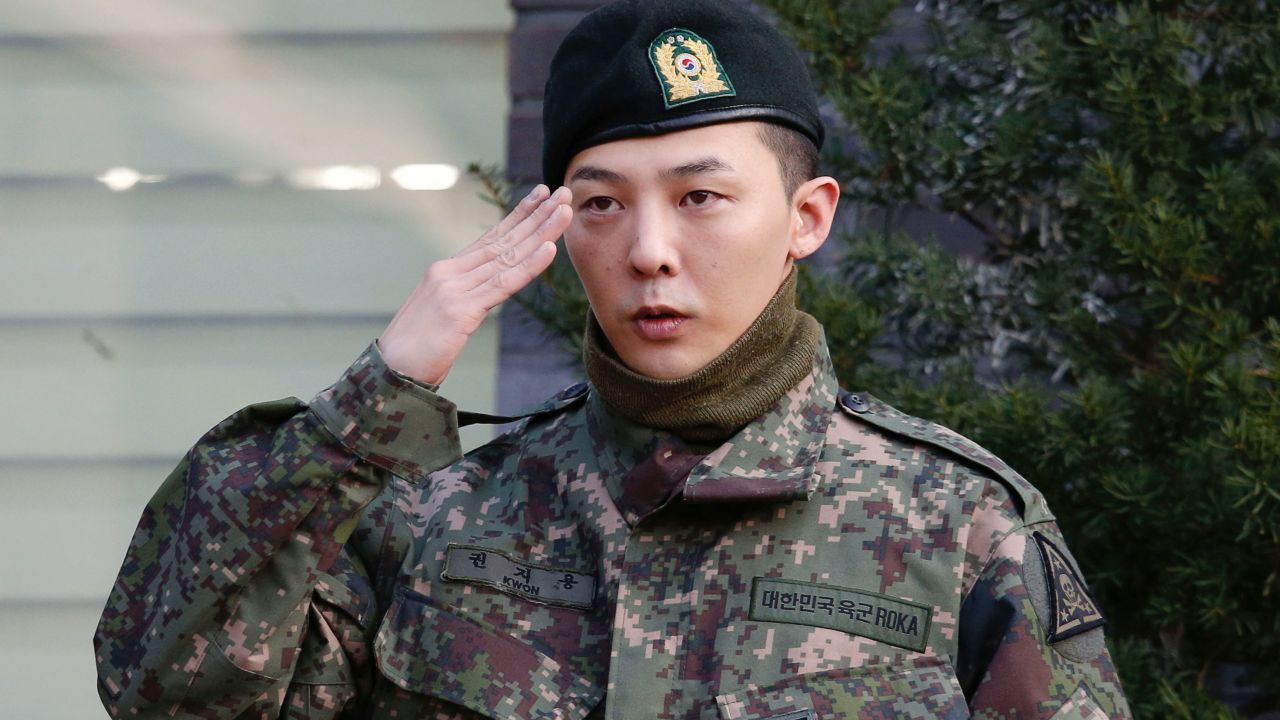 G-Dragon poses for photographs after being discharged from the army in Yongin, South Korea, on October 26, 2019.  