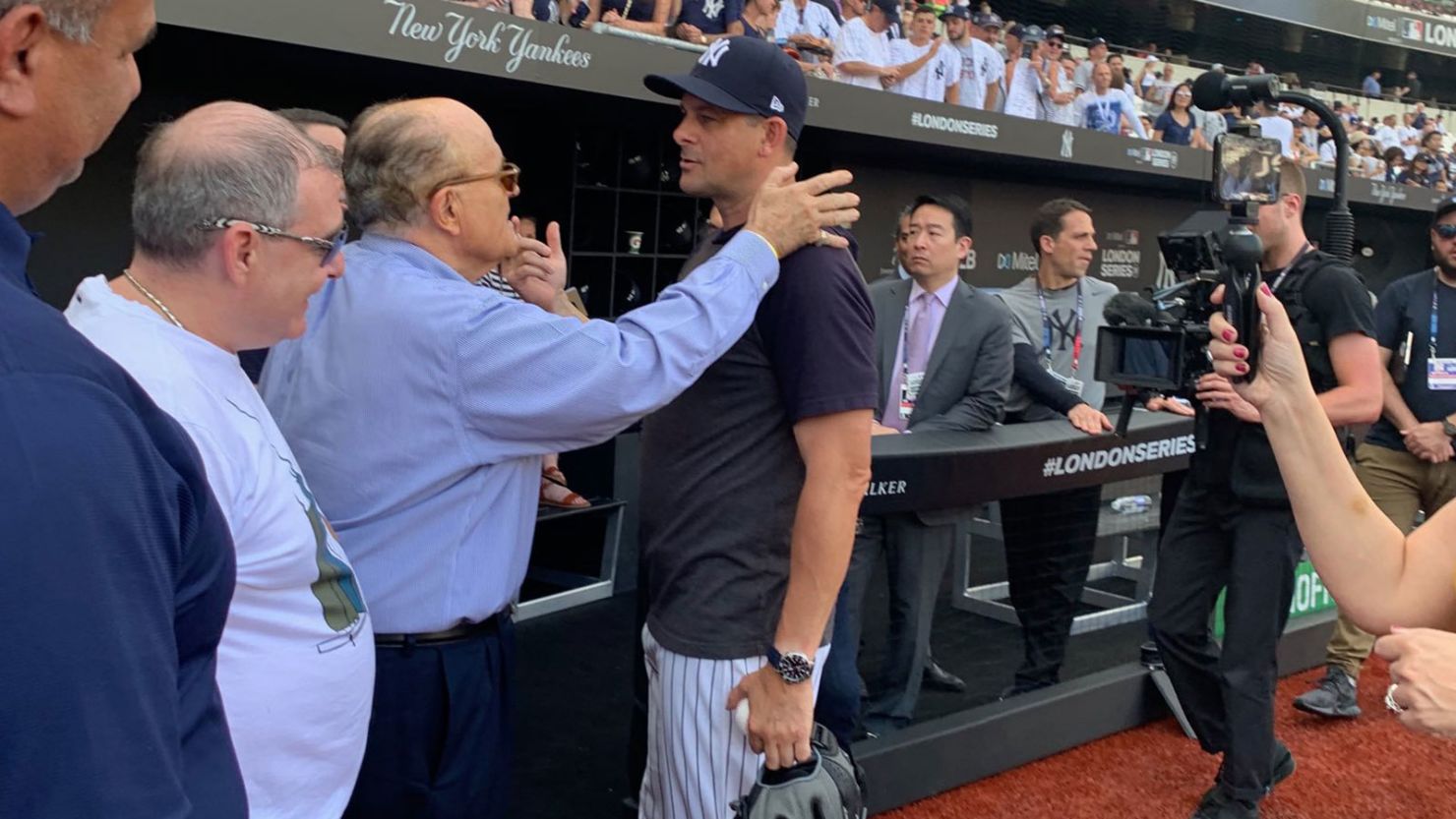 Rudy Giuliani (center) speaks with New York Yankees manager Aaron Boone prior to a game between the Yankees and the Boston Red Sox in London in June 2019.  Lev Parnas, a now-indicted associate of Giuliani's, can be seen standing on Giuliani's right.

Rudy Giuliani/Twitter