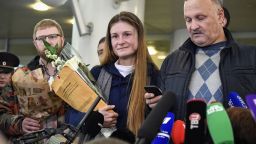 TOPSHOT - Maria Butina (C), who served nine months in a US jail for acting as a Russian government agent talks to the press as she arrives at Moscow's Sheremetyevo airport on October 26, 2019, a day after her release from prison. - She was arrested in July 2018 on allegations of engaging in espionage. In December, Butina entered a plea deal on a charge that she acted as an illegal, unregistered foreign agent, and was sentenced to 18 months in prison, half of which was credited as already served. (Photo by Alexander NEMENOV / AFP) (Photo by ALEXANDER NEMENOV/AFP via Getty Images)