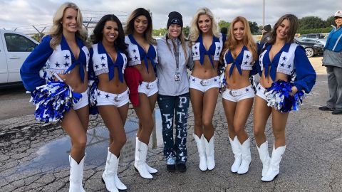 Thomas Jefferson Principal Sandi Massey poses with the Dallas Cowboys' cheerleaders on Saturday.