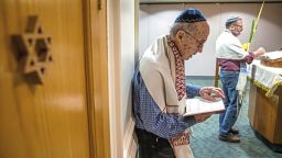 Joe Charny, 91, a survivor from the Tree of Life shooting Oct. 27, 2018, reads during a morning minyan prayer service at Congregation Beth Shalom on Wednesday, Oct. 16, 2019, in the Squirrel Hill neighborhood of Pittsburgh. Since the Tree of Life synagogue shooting last year Beth Shalom has invited members of Tree of Life, New Light and Dor Hadash to join and lead their daily prayer service. (Andrew Rush/Pittsburgh Post-Gazette via AP)