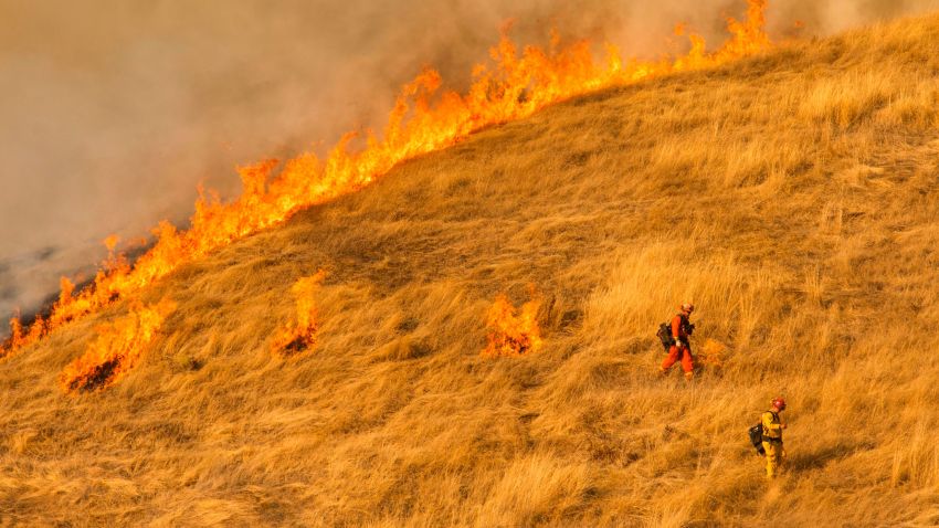 Firefighters set a back fire along a hillside near during firefighting operations to battle the Kincade Fire in Healdsburg, California on October 26, 2019. - US officials on October 26 ordered about 50,000 people to evacuate parts of the San Francisco Bay area in California as hot dry winds are forecast to fan raging wildfires. (Photo by Philip Pacheco / AFP) / The erroneous source appearing in the metadata of this photo by Philip Pacheco has been modified in AFP systems in the following manner: [AFP] instead of [www.philippachecophoto.com]. Please immediately remove the erroneous mention from all your online services and delete it from your servers. If you have been authorized by AFP to distribute it to third parties, please ensure that the same actions are carried out by them. Failure to promptly comply with these instructions will entail liability on your part for any continued or post notification usage. Therefore we thank you very much for all your attention and prompt action. We are sorry for the inconvenience this notification may cause and remain at your disposal for any further information you may require. (Photo by PHILIP PACHECO/AFP via Getty Images)