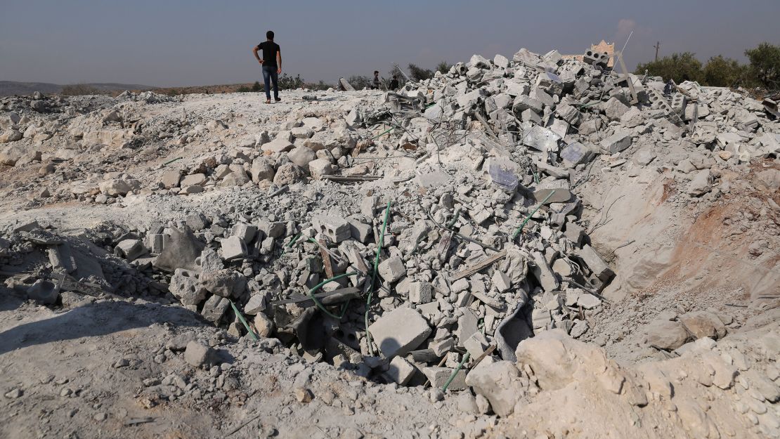 People look at a destroyed houses near the village of Barisha, in Idlib province, Syria, on Oct. 27, 2019, after an operation by the U.S. military which targeted Abu Bakr al-Baghdadi. (AP Photo/Ghaith Alsayed)