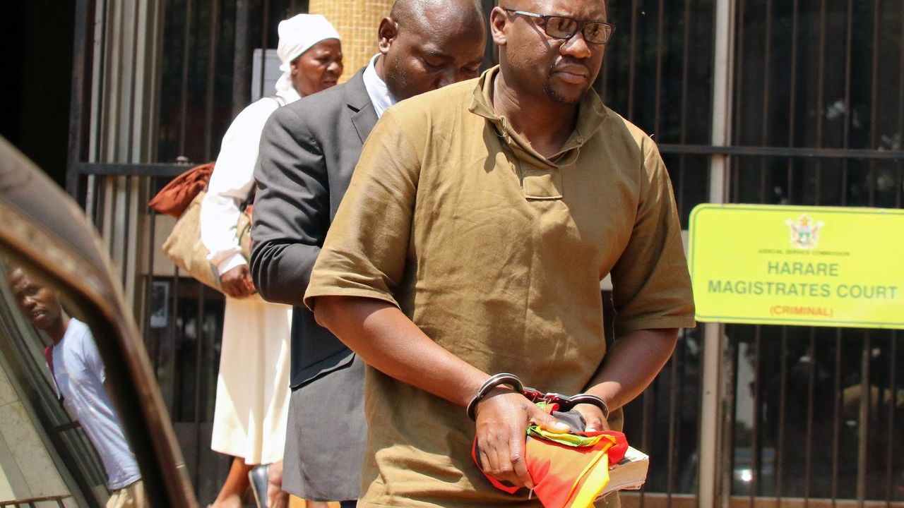 Zimbabwean pastor and activist Evan Mawarire clutches his Bible after being arrested and sent to Harare's Magistrates Court.