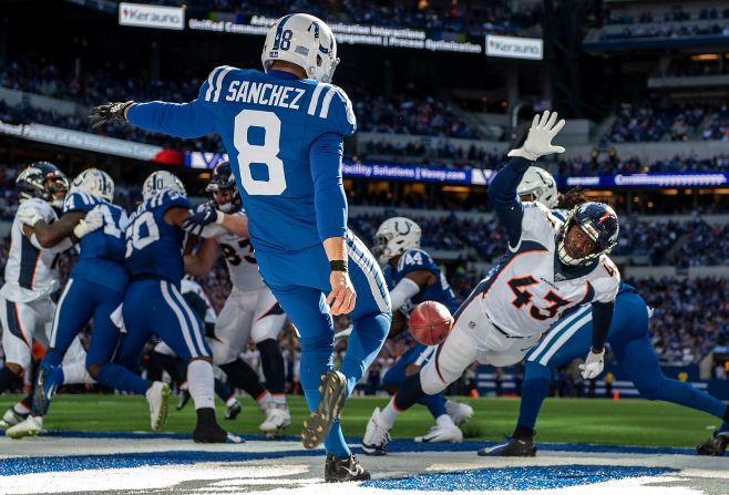 Denver's Joe Jones tries to block a punt by Indianapolis' Rigoberto Sanchez during an NFL game in Indianapolis on Sunday, October 27.