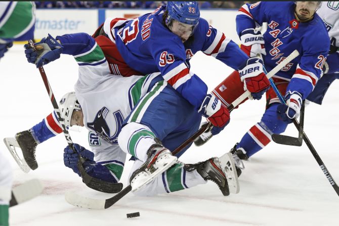 New York Rangers center Mika Zibanejad collides with Vancouver's Jay Beagle, bottom, during an NHL game in New York on Sunday, October 20.