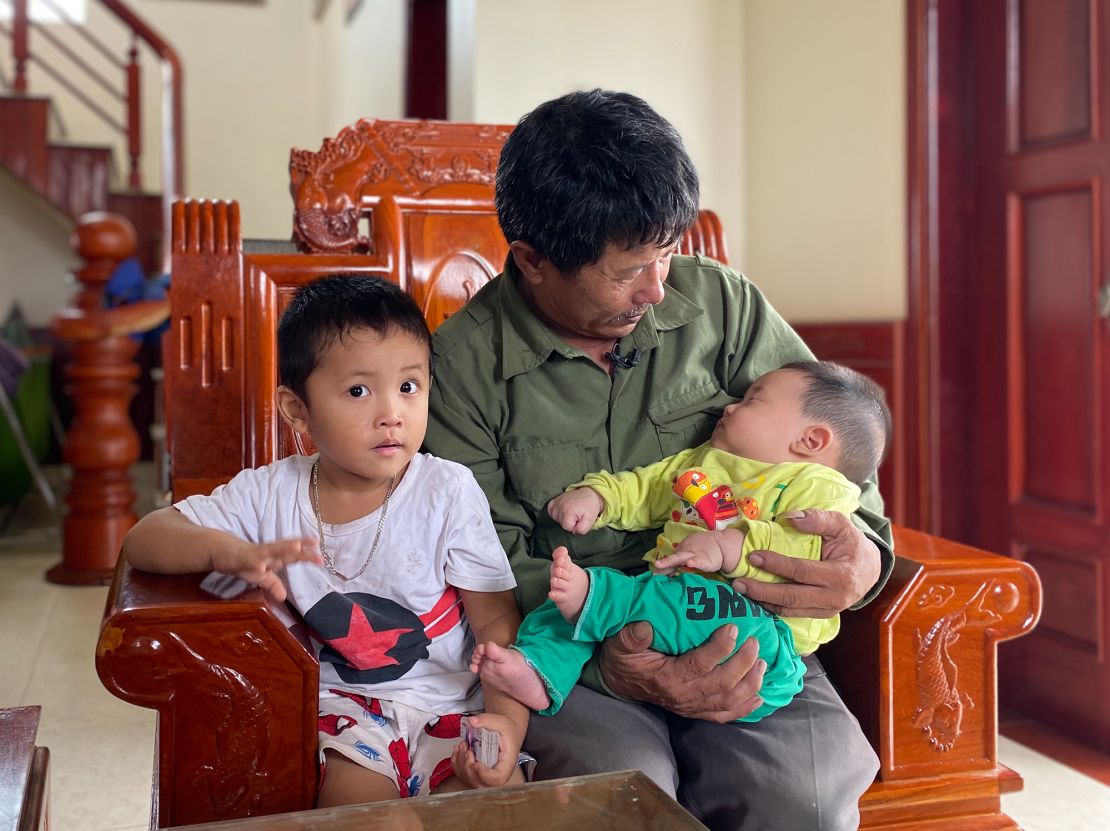 Le Minh Tuan and two of his grandchildren. Their father - Le's son - is believed to have died as he tried to make his way to the UK.
