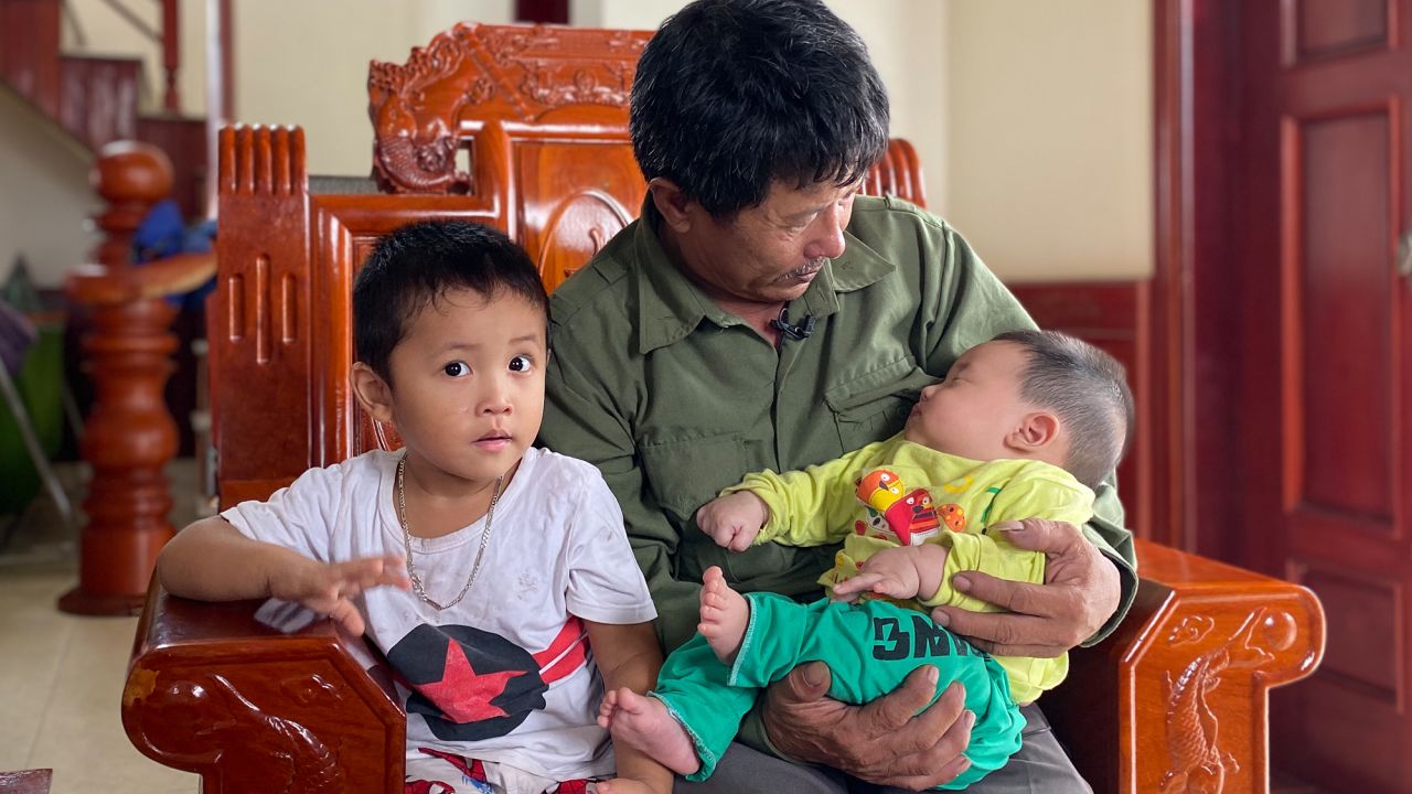 Le Minh Tuan and two of his grandchildren. Their father - Le's son - is believed to have died as he tried to make his way to the UK.