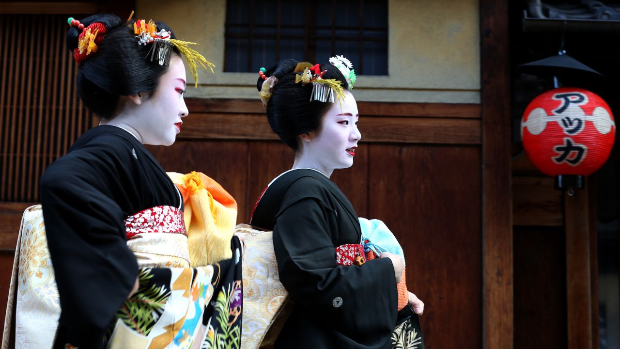 Japanese geisha and their apprentices walk in the street during an annual new year's ceremony at the Gion Kobu Kaburenjo Theater on January 7, 2016. The area is one of Kyoto's most popular tourist destinations. 