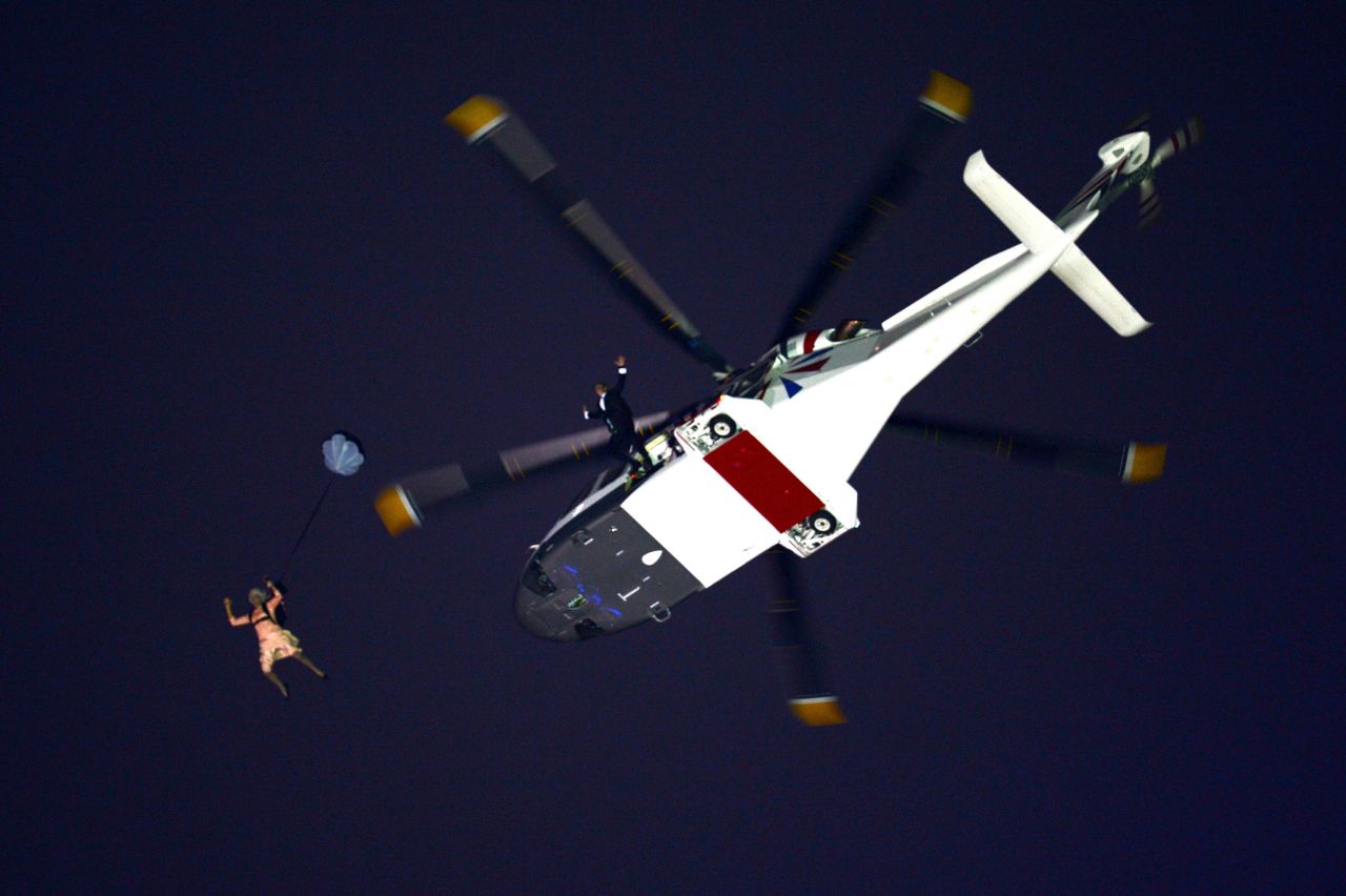  A performer in the role of Queen Elizabeth II parachutes out of a helicopter hovering above the stadium during the Opening Ceremony of the London 2012 Olympic Games.