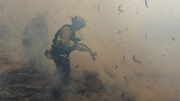 Firefighters from San Matteo work to extinguish flames from the Kincade Fire in Sonoma County, Calif., on Sunday, Oct. 27, 2019. (AP Photo/Ethan Swope)