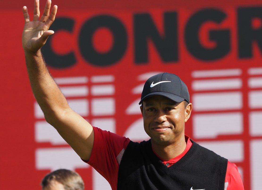 Woods waves after winning his 82nd PGA Tour title Sunday. 