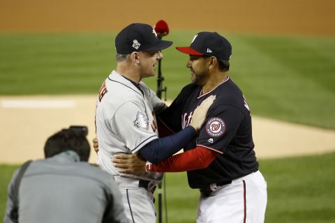 Houston manager A.J. Hinch, left, and Washington manager Dave Martinez embrace each other prior to Game 3.