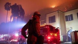 A firefighter watches a flames approach the Mandeville Canyon neighborhood during the Getty fire, Monday, Oct. 28, 2019, in Los Angeles, California.