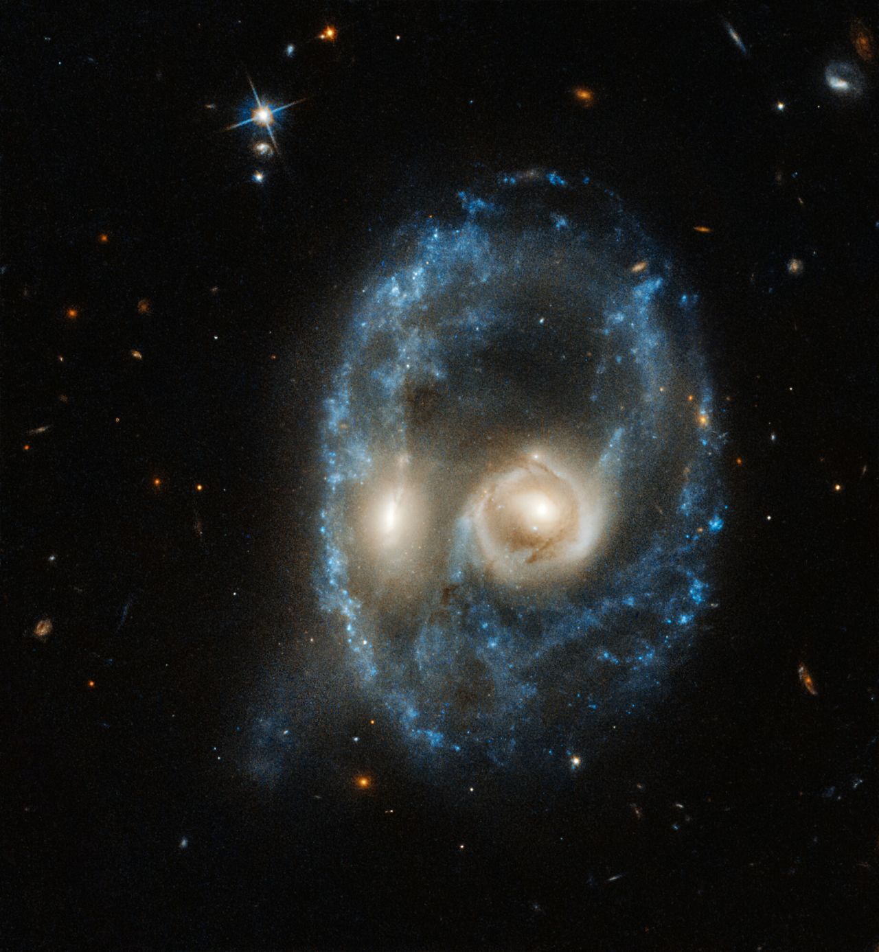 This new image from the NASA/ESA Hubble Space Telescope captures two galaxies of equal size in a collision that appears to resemble a ghostly face. This observation was made on 19 June 2019 in visible light by the telescope's Advanced Camera for Surveys.