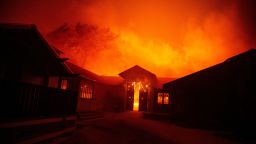 The doors to the Soda Rock Winery burst open as it burns in Healdsburg, California on October 27, 2019. - Powerful winds were fanning wildfires in northern California in "potentially historic fire" conditions, authorities said October 27, as tens of thousands of people were ordered to evacuate and sweeping power cuts began in the US state. (Photo by Josh Edelson / AFP) (Photo by JOSH EDELSON/AFP via Getty Images)