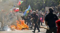 Demonstrators with Mapuche indigenous flags make a bonfire as they protest in Santiago, on October 28, 2019. - Chilean President Sebastian Pinera unveiled a major cabinet reshuffle on Monday as he battles to find a response to more than a week of street protests that have left at least 20 people dead. (Photo by Martin BERNETTI / AFP) (Photo by MARTIN BERNETTI/AFP via Getty Images)