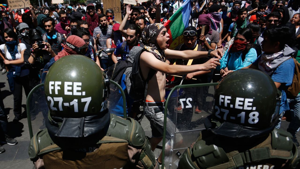 Demonstrators protest against President of Chile Sebastian Piñera during his announcenment of changes in his cabinet at Palacio de La Moneda on October 28, 2019.