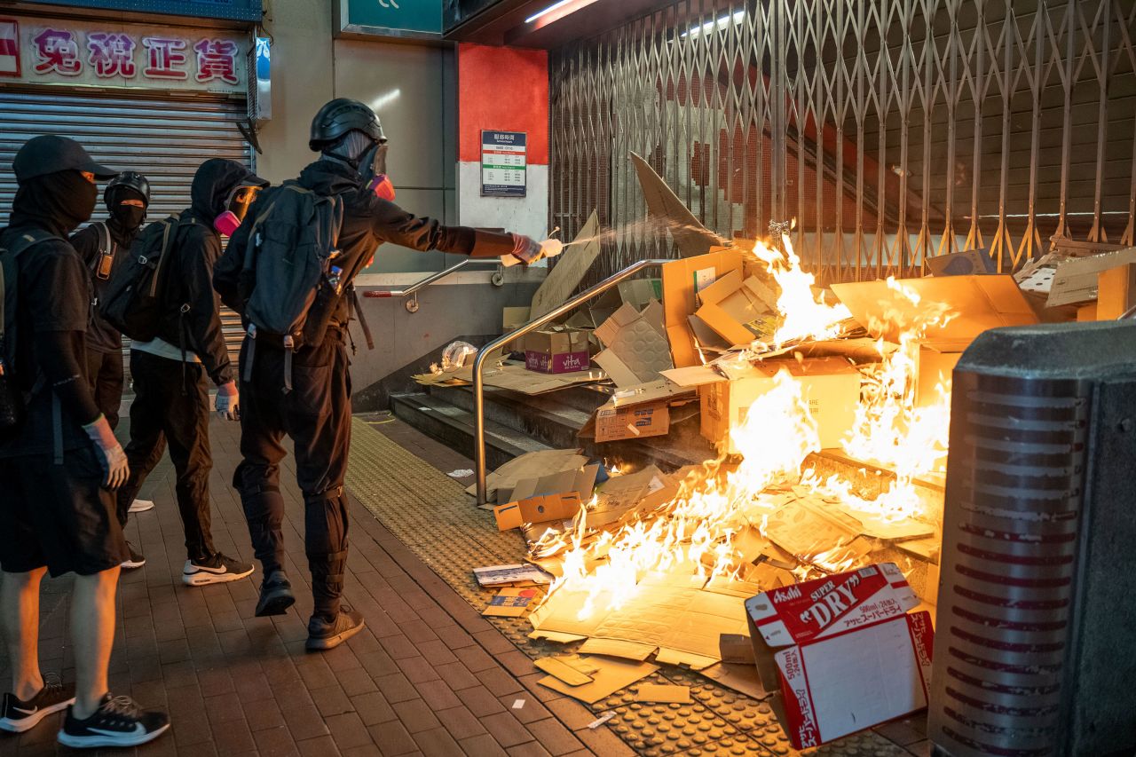 Protesters start a fire in front of the MTR station during demonstration on October 27.