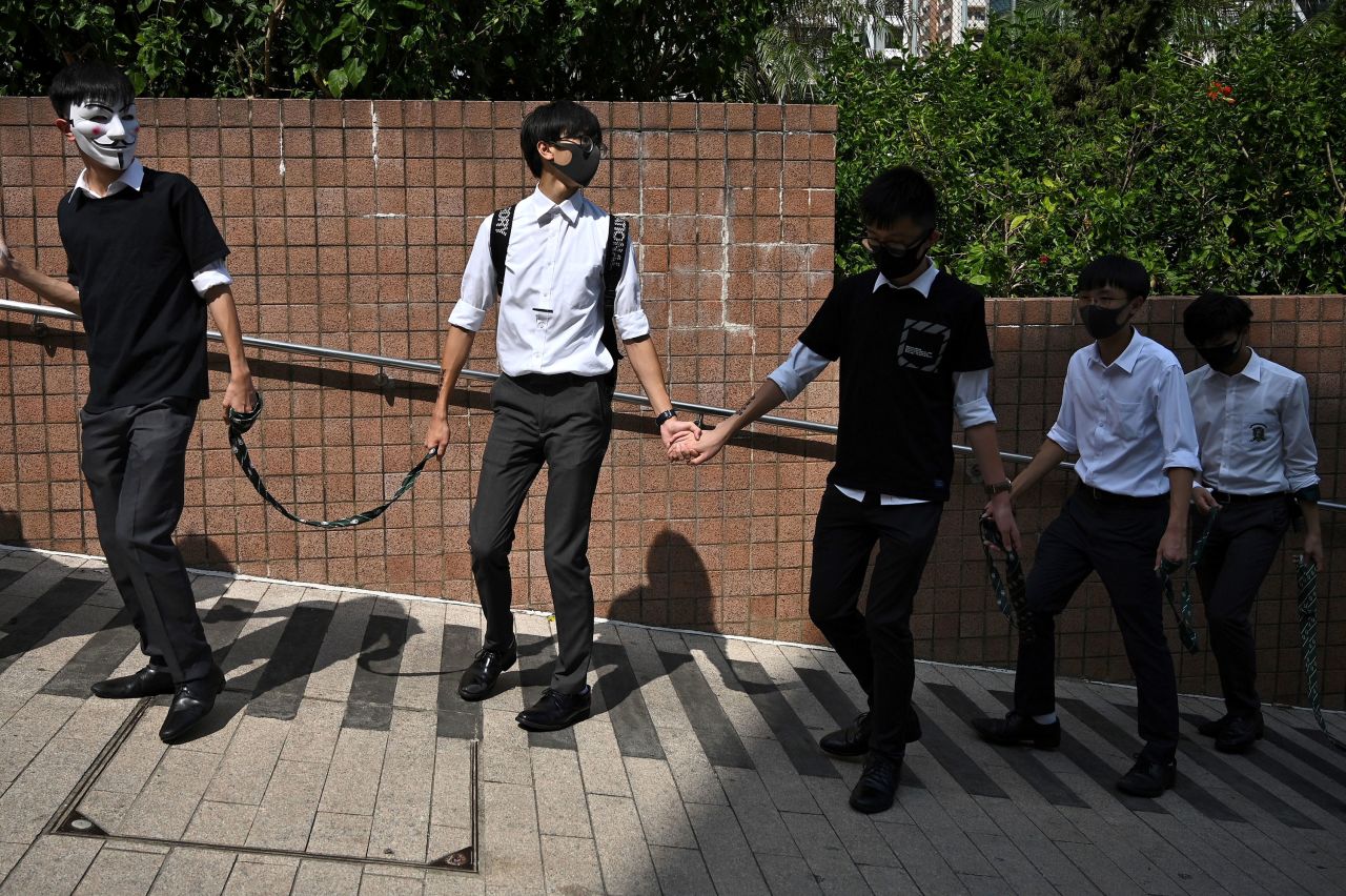 High school students take part in a human chain rally outside Kowloon park in Hong Kong on October 25.