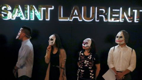 Hong Kong protesters wear masks, including one of the Joker, on October 18, 2019.