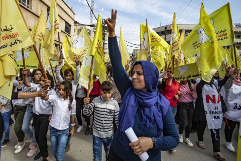 Syrian Kurds wave flags in Qamishli as they take part in a demonstration in support of the Syrian Democratic Forces on October 28.