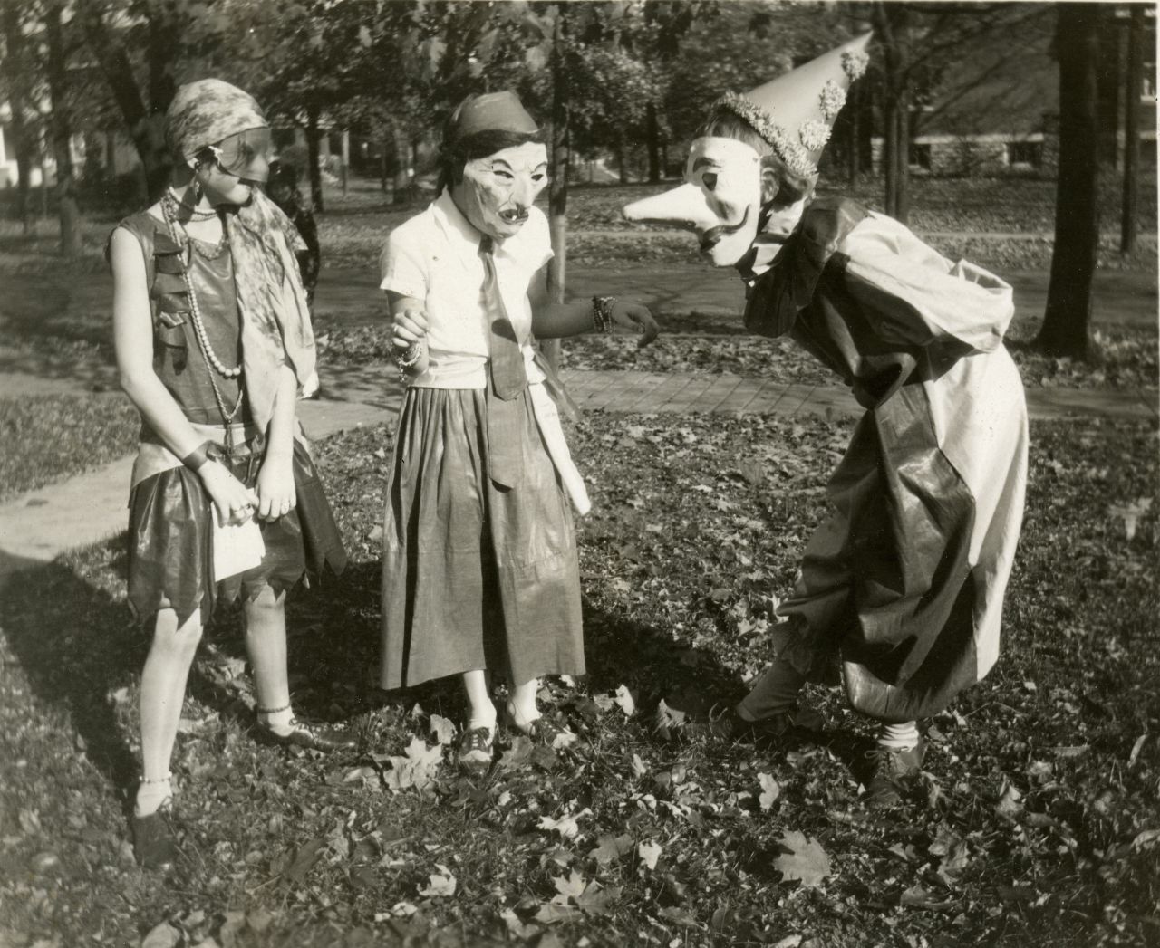 Three girls prepare for Halloween festivities in the College Hill neighborhood of Cincinnati, Ohio, 1929.