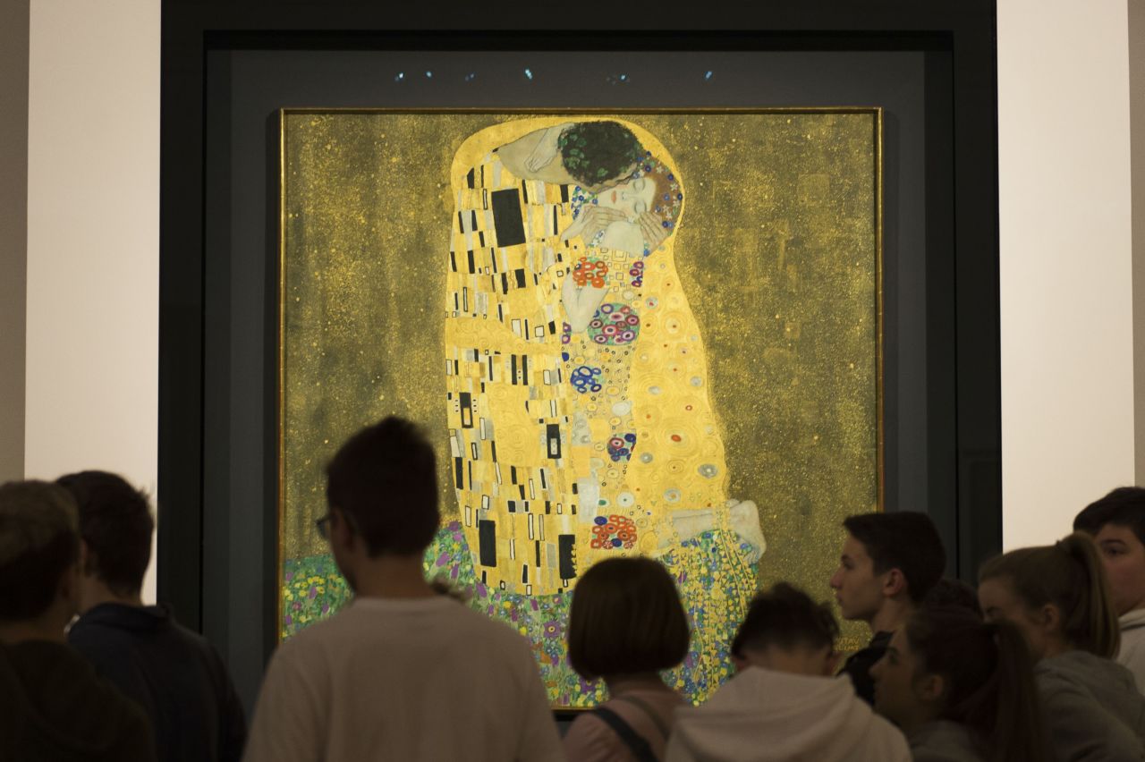 Visitors admire "The Kiss" by Gustav Klimt at the Upper Belvedere in Vienna, Austria.