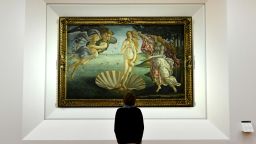 A journalist looks at "The birth of Venus" painted in the mid 1480s by Italian painter Sandro Botticelli during a press preview for the reopening of the rooms dedicated to Pollaiolo and Botticelli, at the Uffizi Gallery in Florence, on October 17, 2016. The articulation of the space has been reorganized for to faciliate the visit thanks to a large donation by the "Friends of Florence Foundation". / AFP / ALBERTO PIZZOLI / RESTRICTED TO EDITORIAL USE - MANDATORY MENTION OF THE ARTIST UPON PUBLICATION - TO ILLUSTRATE THE EVENT AS SPECIFIED IN THE CAPTION        (Photo credit should read ALBERTO PIZZOLI/AFP/Getty Images)