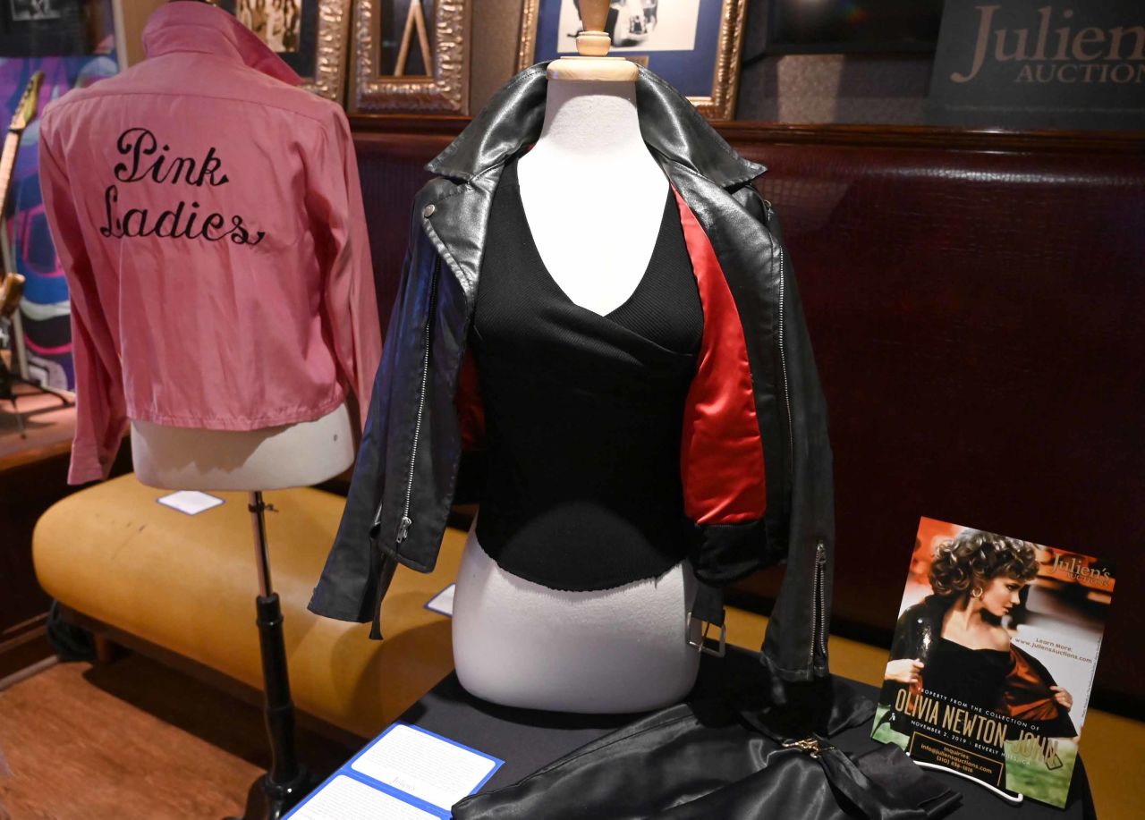 Olivia Newton-John's auctioned costumes from "Grease" and including her iconic leather jacket to benefit her cancer and wellness center.