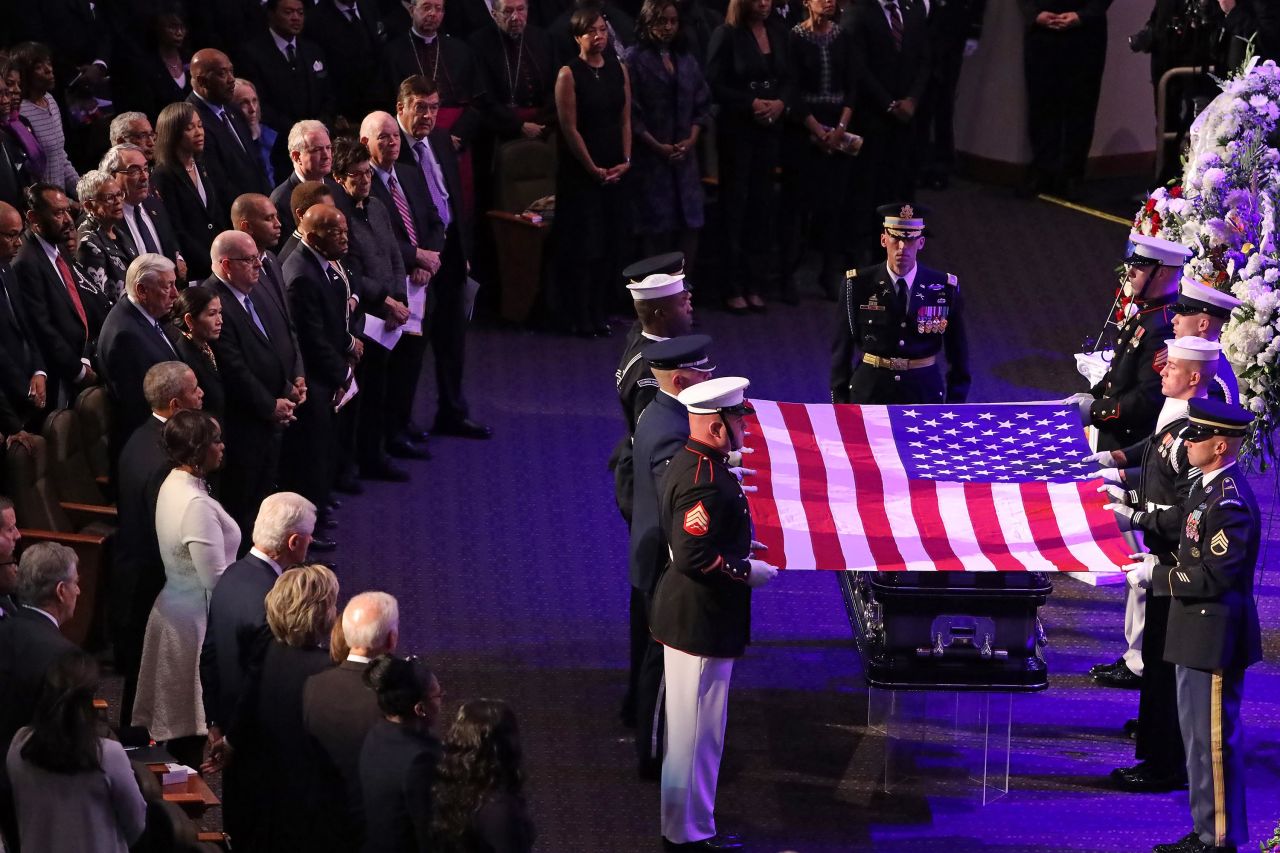 An honor guard drapes a flag over Cummings' casket during his funeral service in Baltimore.
