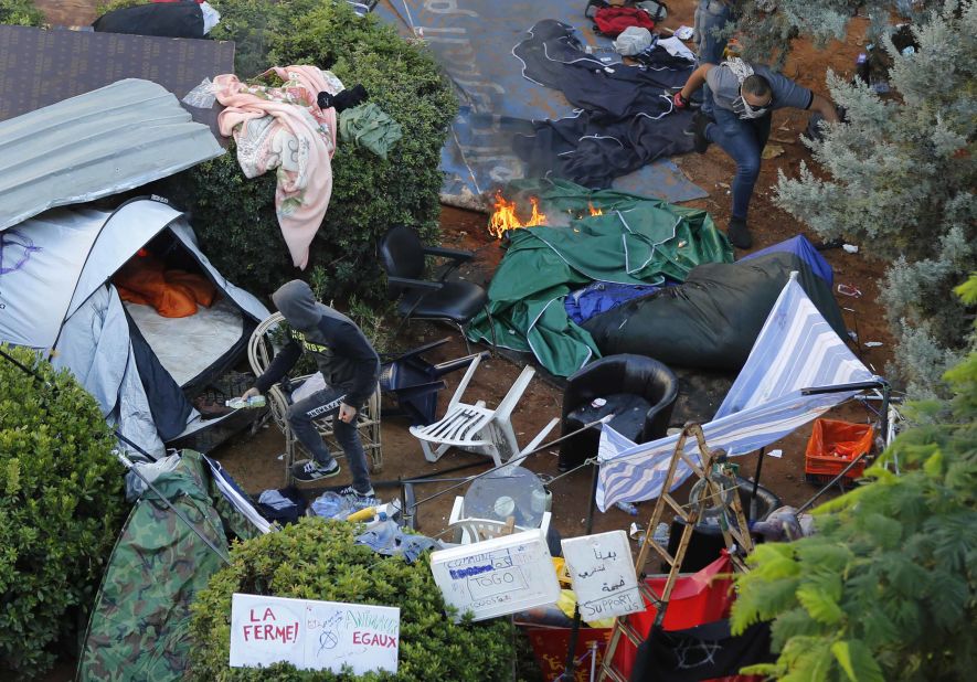 Hezbollah supporters burn tents in the camp set up by anti-government protesters near the government palace.