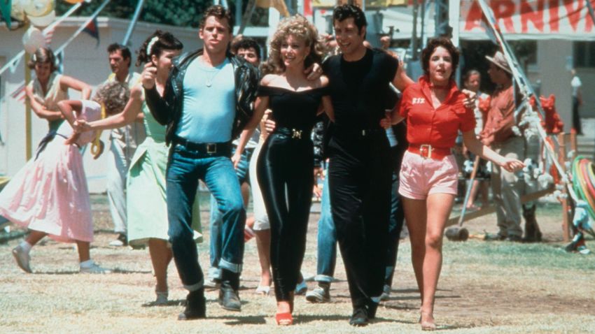 1978:  Left to right: actors Jeff Conaway, Olivia Newton-John, John Travolta and Stockard Channing walk arm in arm at a carnival in a still from the film, 'Grease' directed by Randal Kleiser.  (Photo by Paramount Pictures/Fotos International/Getty Images)