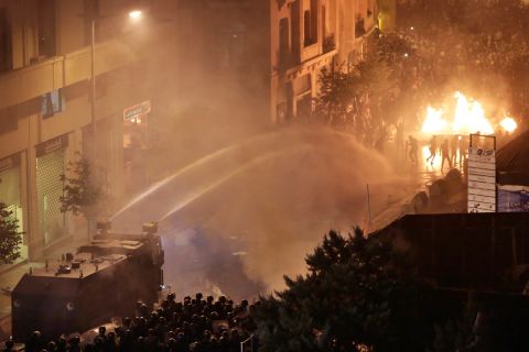 Lebanese police use a water cannon on anti-government protesters on October 18.