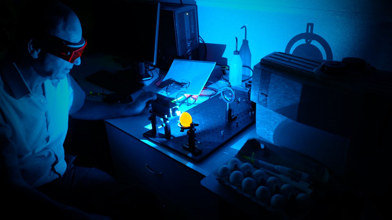 Professor Dani Offen, eggXYt's co-founder, uses gene-editing technology to identify an egg's gender before it hatches. Male eggs emit a light fluorescent grow.