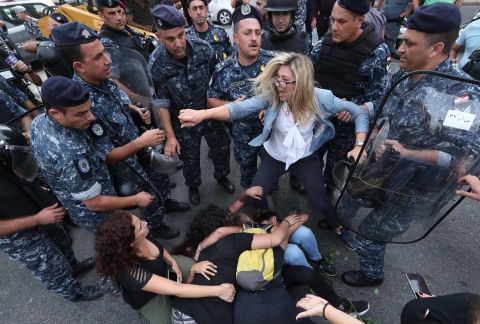 A Lebanese demonstrator scuffles with security forces trying to disperse protesters who were blocking a major bridge in Beirut on Sunday, October 27.