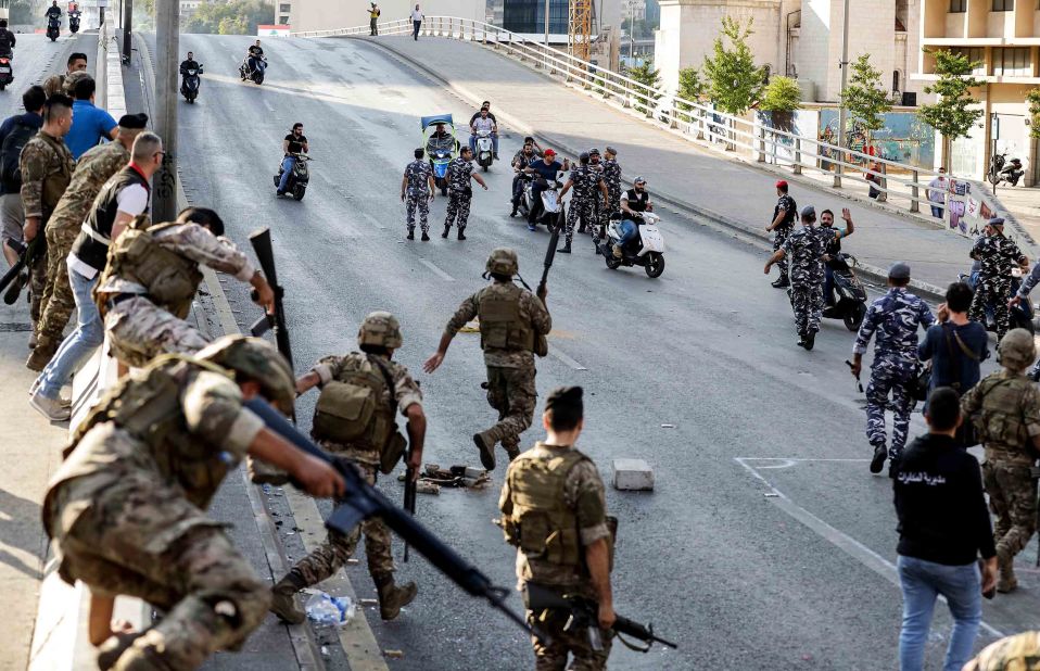 Members of the Lebanese army, left, help intervene between clashing groups of protesters and counter-protesters on a highway in central Beirut.