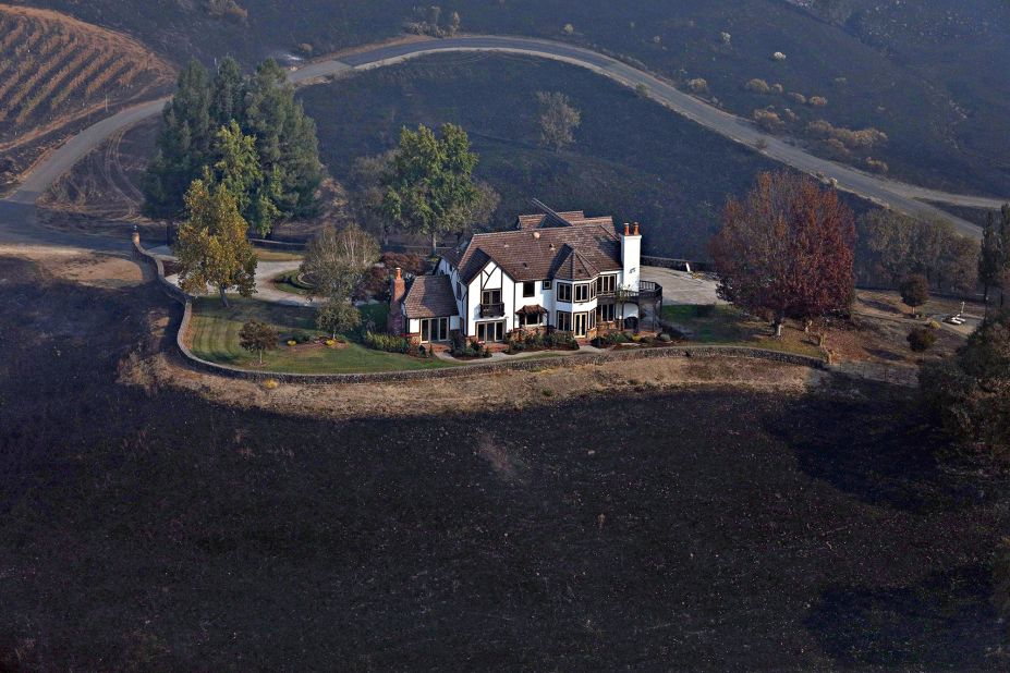 A home between Healdsburg and Windsor is surrounded by charred ground on October 29.