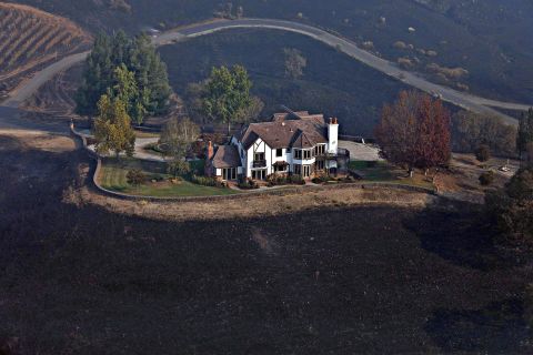 A home between Healdsburg and Windsor is surrounded by charred ground on October 29. 