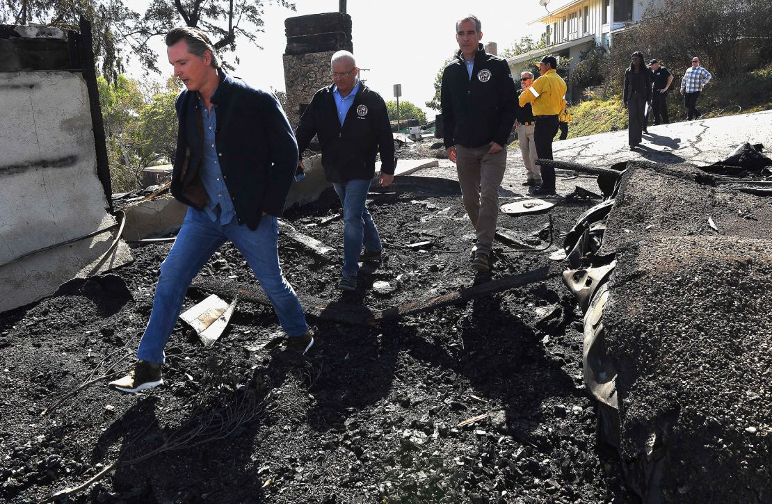 From left, California Governor Gavin Newsom, L.A. City Councilman Mike Bonin, and L.A. City Mayor Eric Garcetti tour a burned home along Tigertail Road in Brentwood, California.