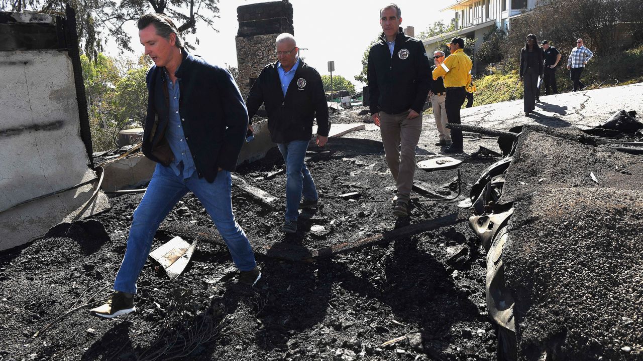 From left, California Governor Gavin Newsom, L.A. City Councilman Mike Bonin, and L.A. City Mayor Eric Garcetti tour a burned home along Tigertail Road in Brentwood, California.